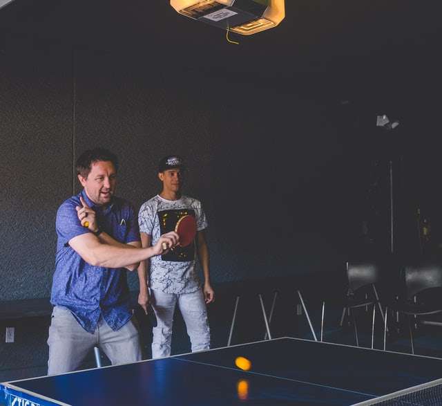 Doubles partner standing far away from table
