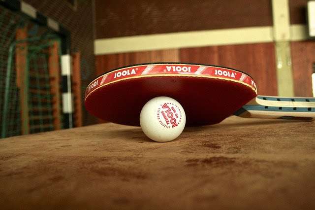 Table tennis bat and ball on table